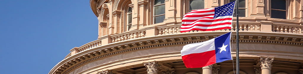 government building with US national flag and Texas state flag