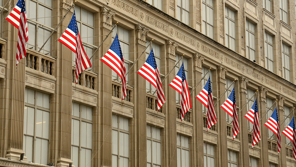 Government Contracting banner image: Building with many American flags