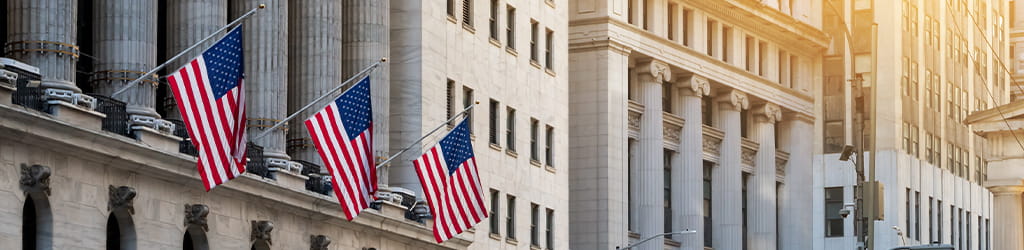 wall street buildings with US flags