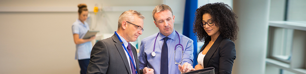 hospital employees discussing and taking notes