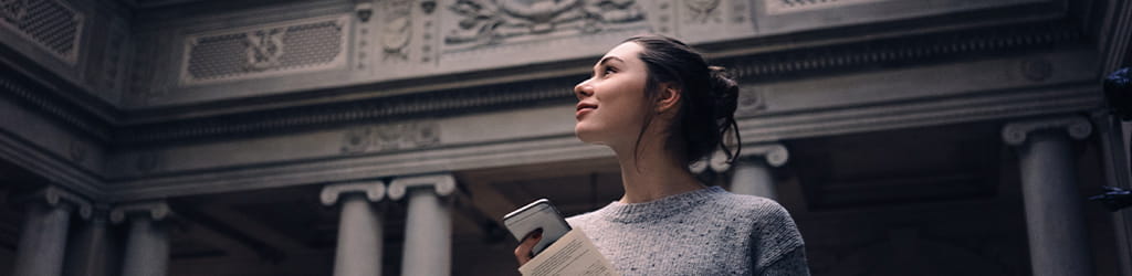 woman holding phone in government building