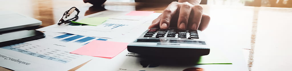 A calculator on a desk with some documents