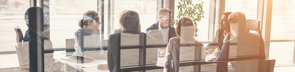 a group of colleagues having a round table discussion illustrating financial modeling and decision analytics services