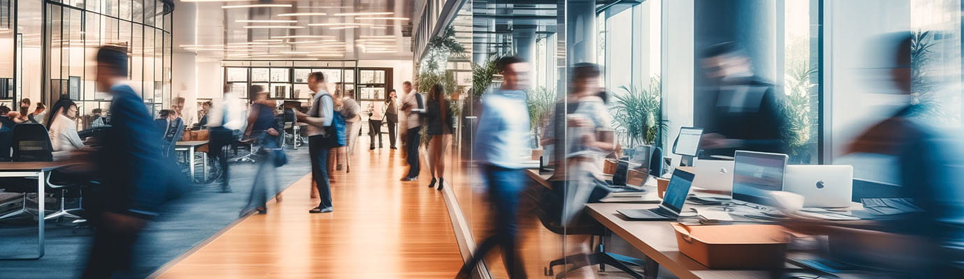 an office building filled with people moving around quickly