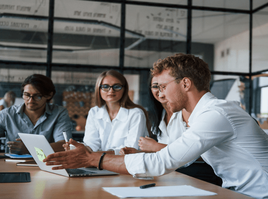 a group of people talking at a table