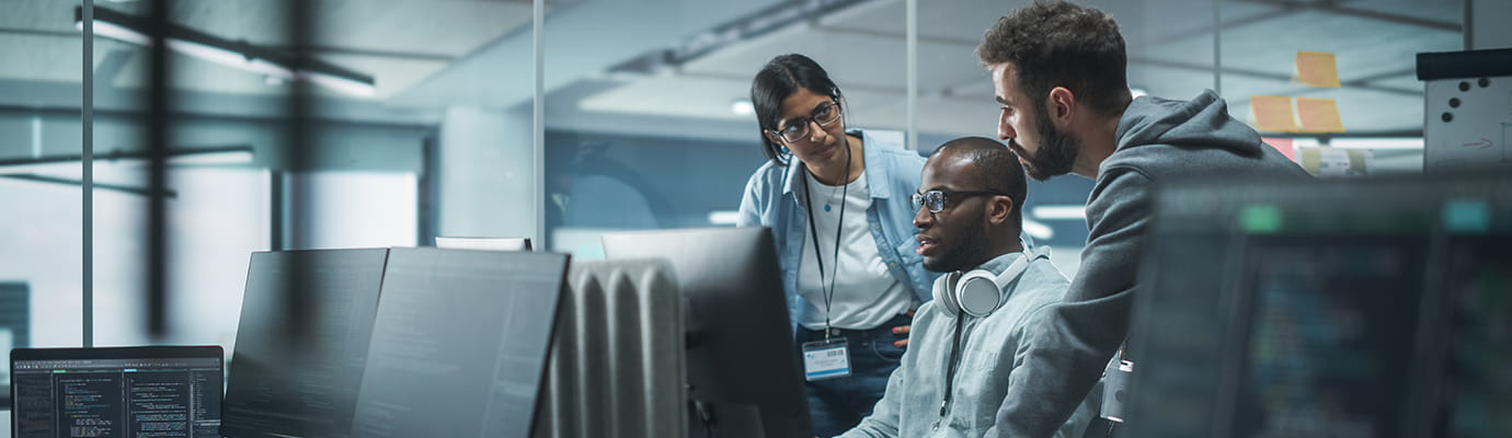 three coworkers working on a laptop