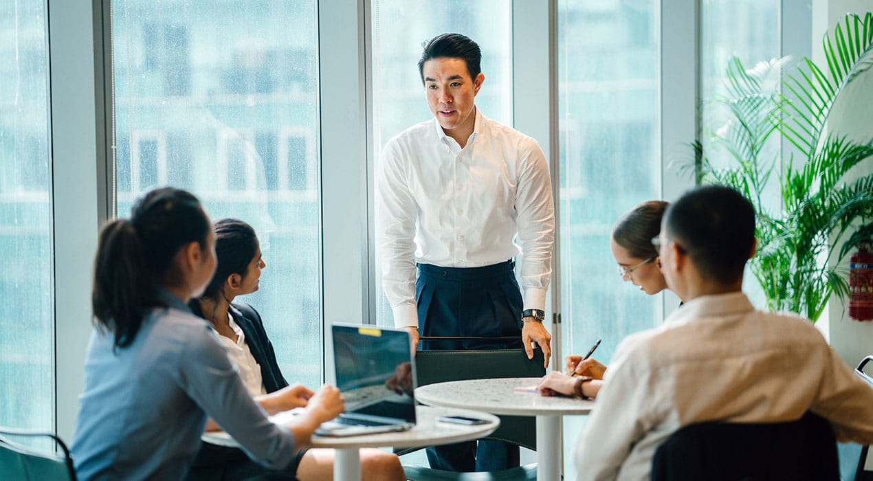 employees having a discussion in a boardroom