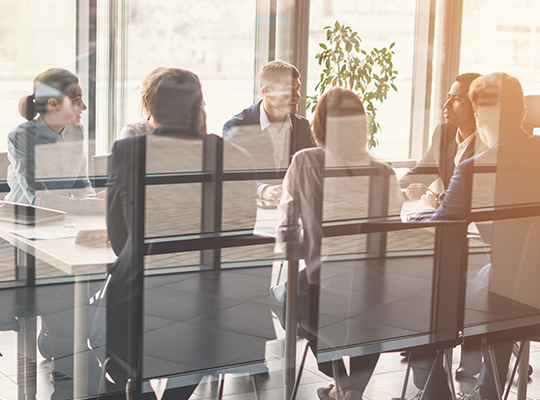 a team sitting at a table for a business meeting