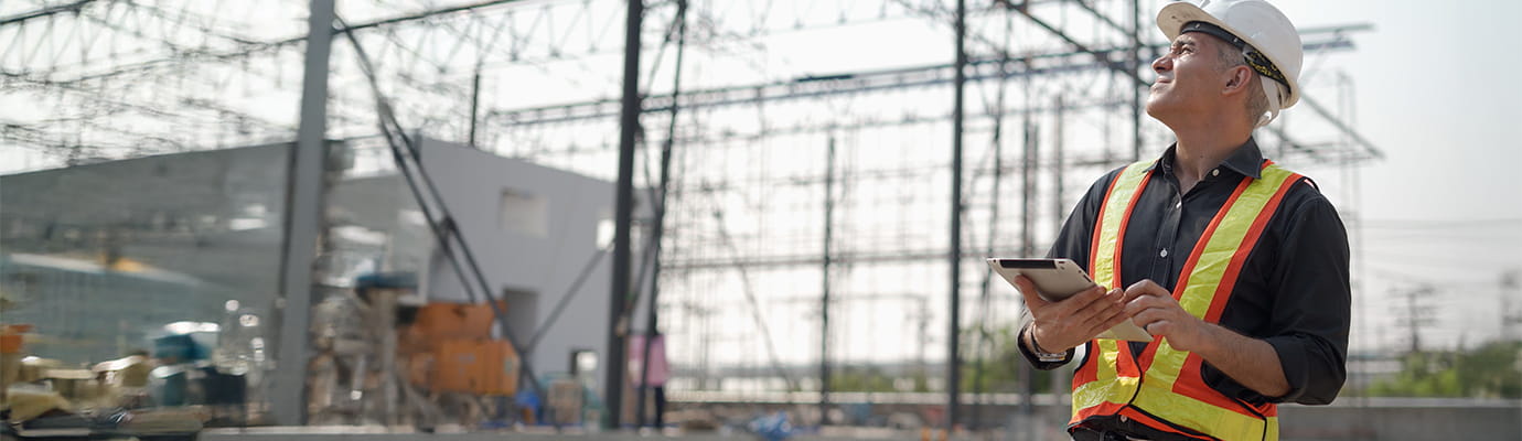 a construction worker reviewing a dig site