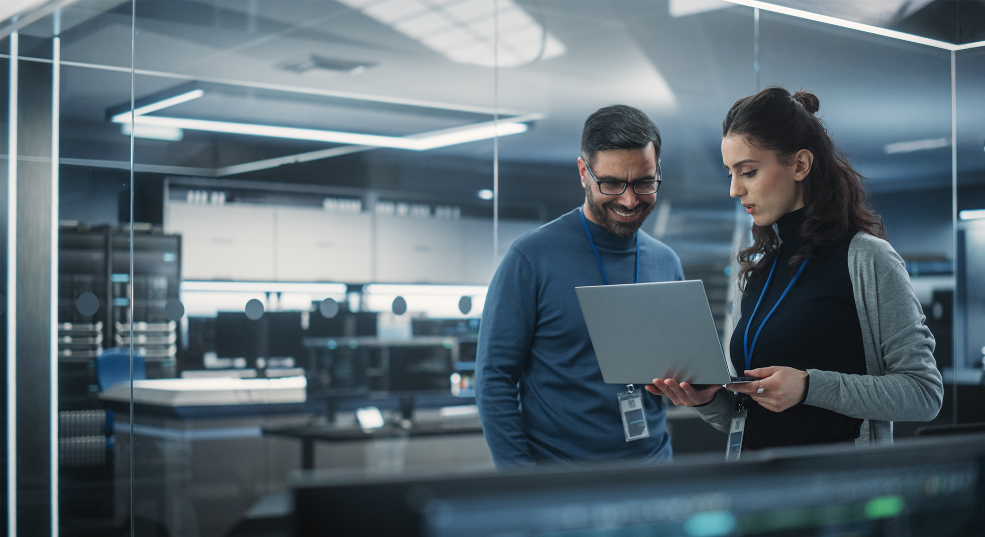 two coworkers reviewing work on a laptop computer