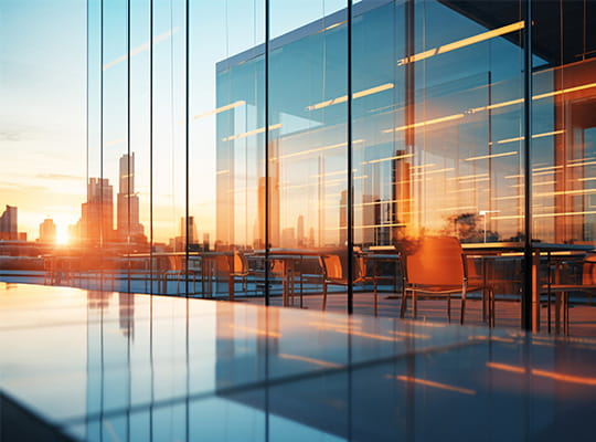 exterior of a glass building at sunset