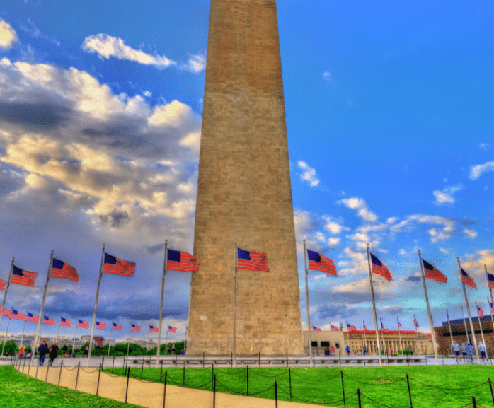 government building surrounded by US flags