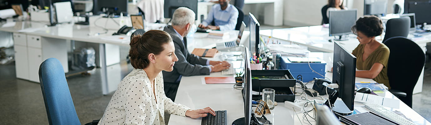 colleagues working at a desk in an office