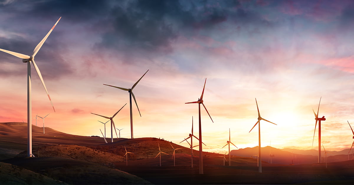 windmills in front of a sunset