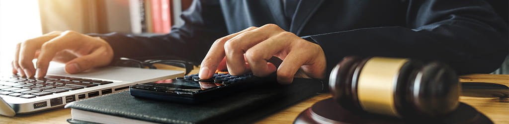 laptop and a calculator with a person working