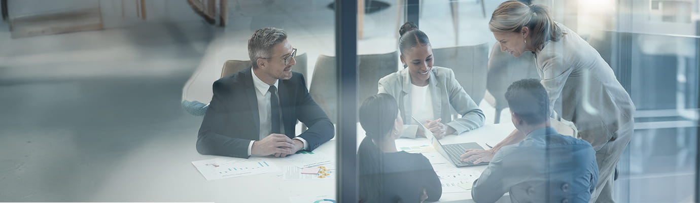 a team sitting at a meeting table
